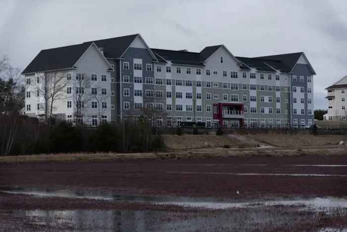 Large hospitality building beside a cranberry bog
